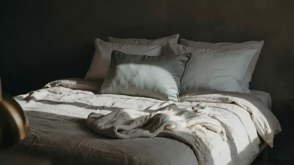 Master bedroom ideas showing layered linen bedding with euro pillows and textured throw