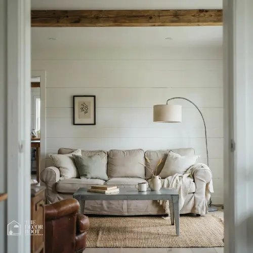 Cozy farmhouse living room with shiplap walls and neutral linen sofa