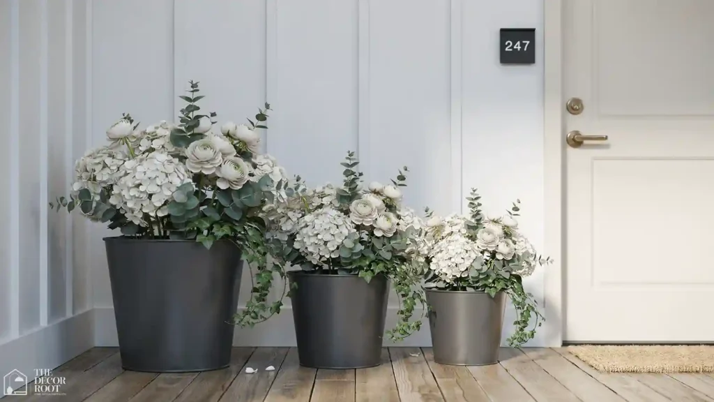 Front porch flower pot idea featuring matte black metal pot trio