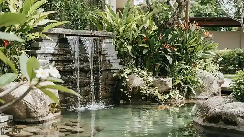 Garden pool design with stone waterfall feature and boulders